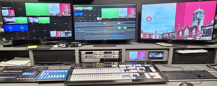 a recording studio control area with screens